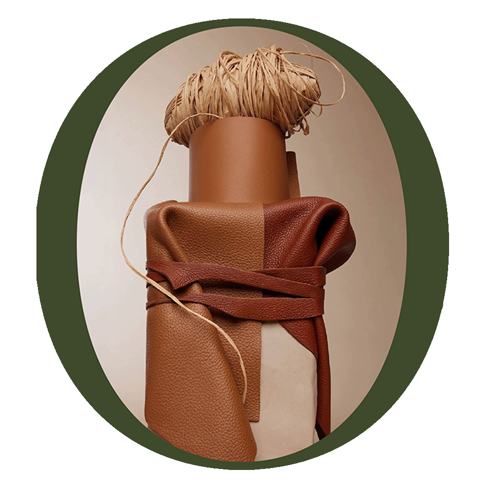 Brown leather wrapped around a form with natural raffia fibres on top, styled product shot for premium packaging